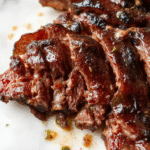 A perfectly cooked beef brisket resting on a rustic wooden platter, sliced to reveal tender, juicy, and richly flavored meat with a caramelized crust, garnished with fresh herbs, surrounded by side dishes, all styled in a warm inviting kitchen setting with vibrant colors and textures.